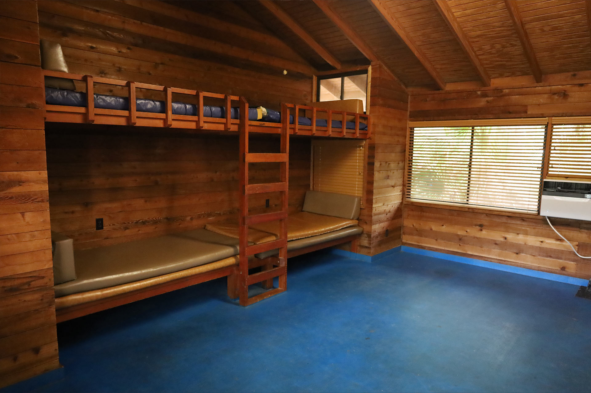 The spacious cabins have a full bathroom with a shower, kitchen, counter style table, bunk beds for 4, and a shared enclosed lanai.