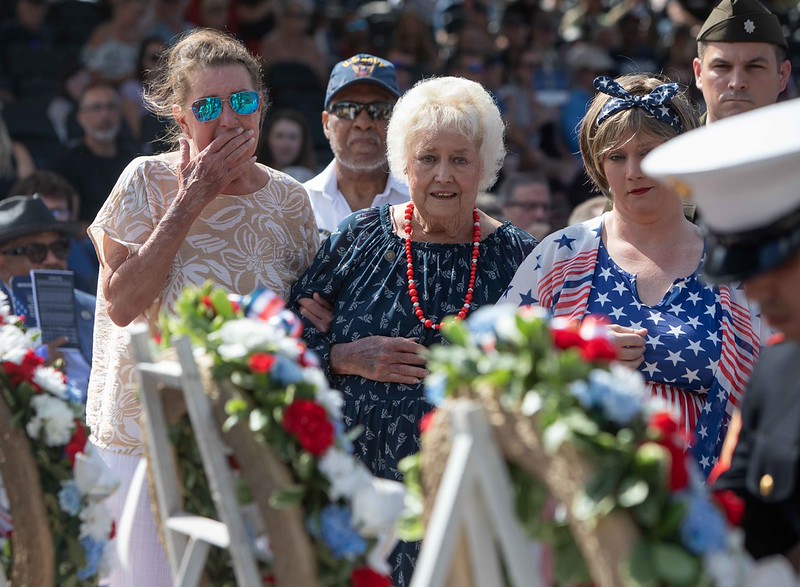 Three women at Memorial Day showing respect at wreaths