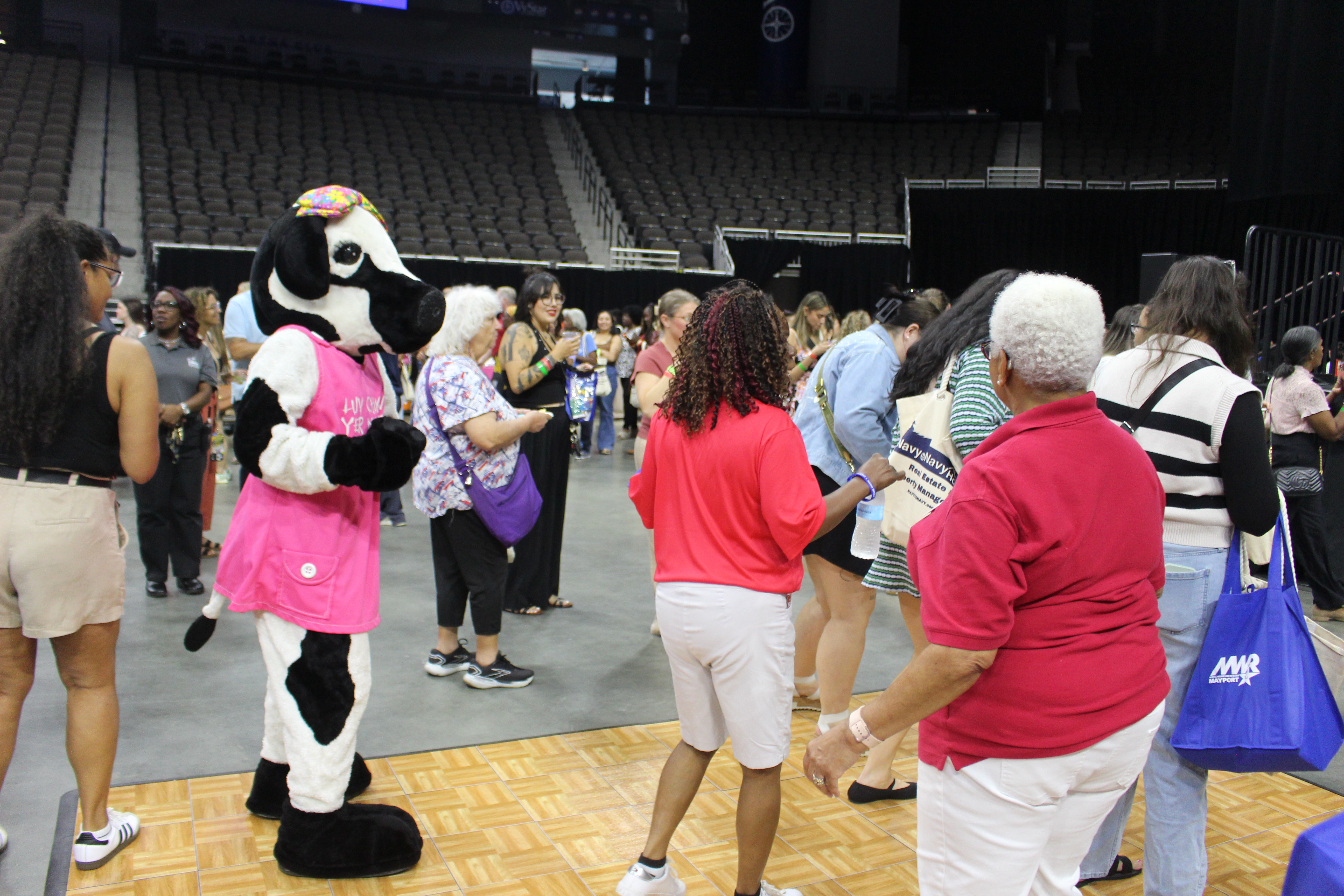 Ladies and Chik-fil-a cow dancing on the dance floor at Spouses Night Out 2026