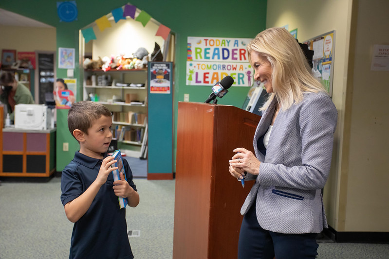 Mayor deegan talking with young boy in library