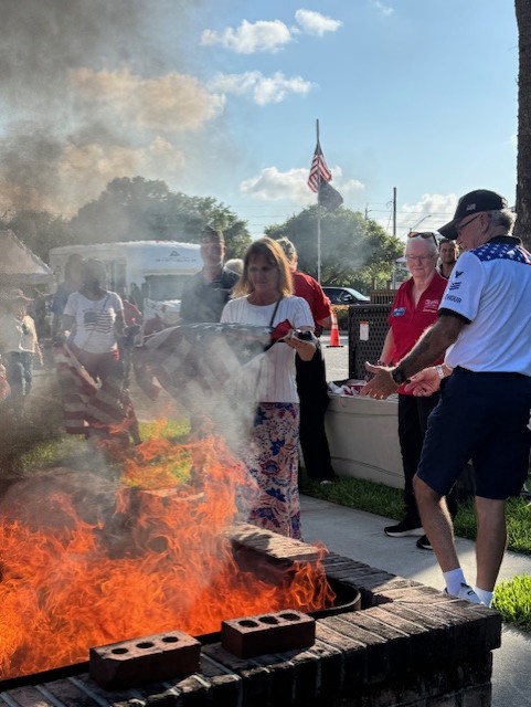 COJ MAVD Tiffany Morales Outreach Manager preparing a flag for a respectful retirement at the 250 Flag Retirement Ceremony at American Legion 283