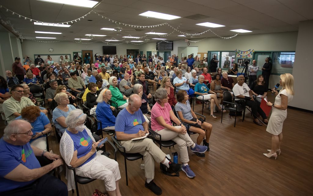 Mayor speaking in front of room full of people