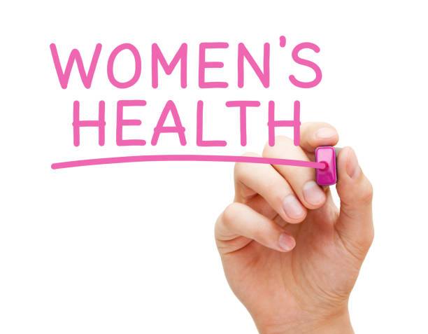 a hand writing Women's health word in pink ink 