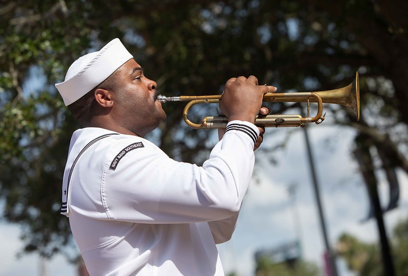 A Navy sailor playing trumpet at Memorial Day 2026 service