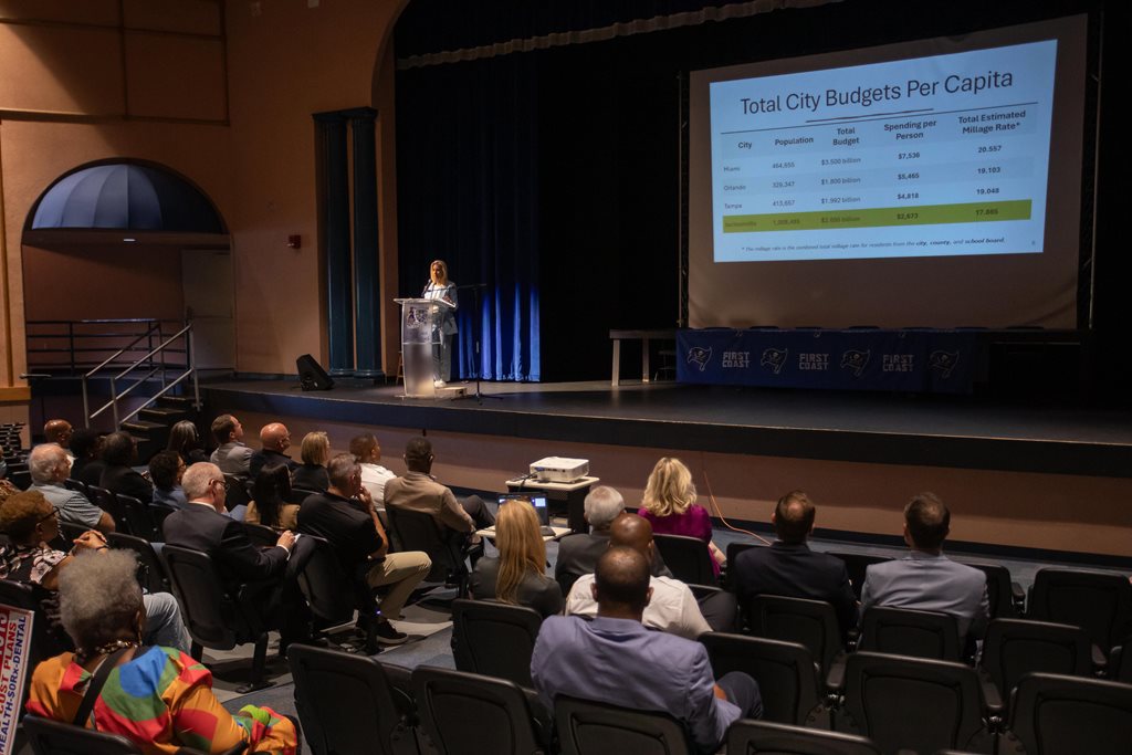 Mayor presenting powerpoint presentation from stage