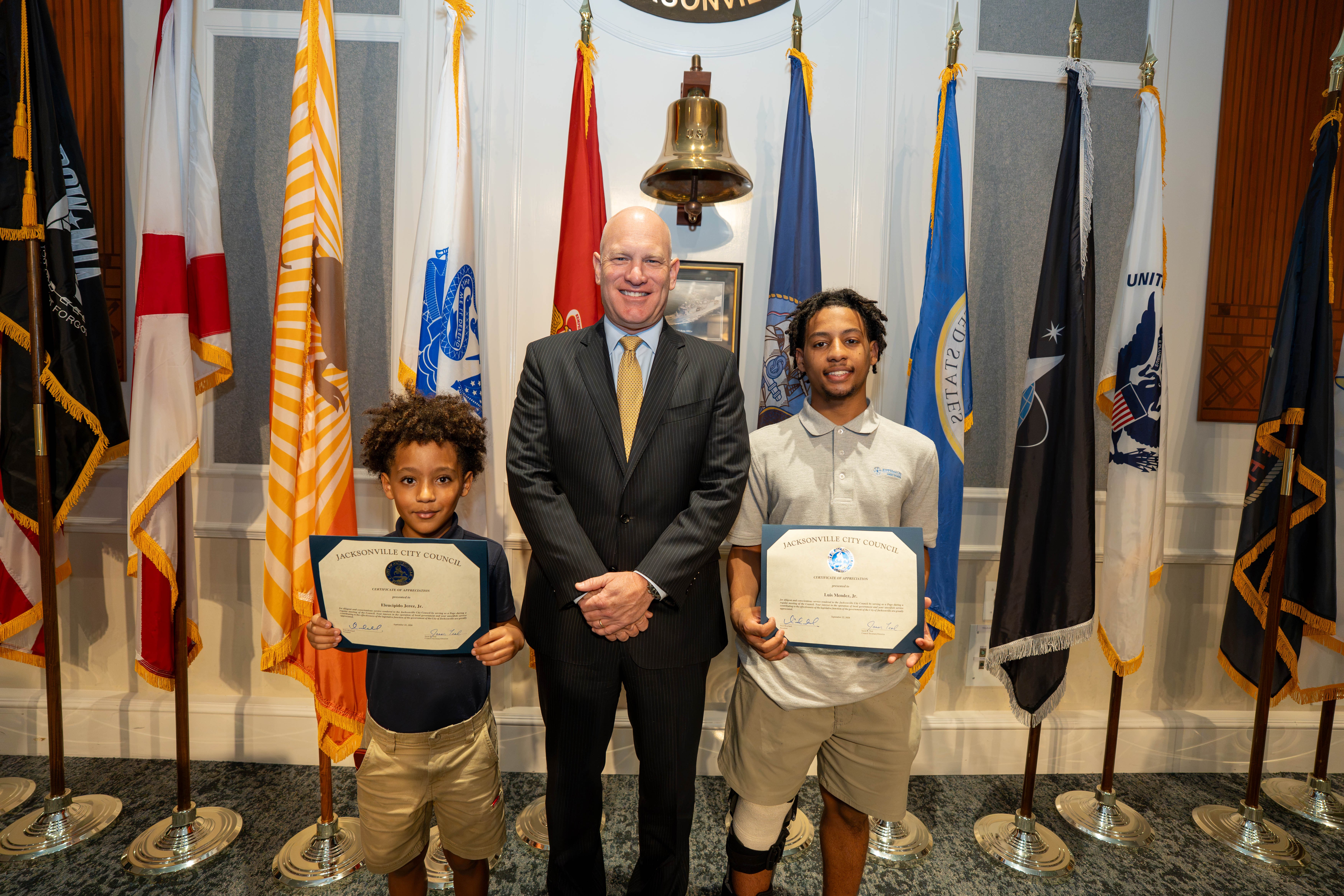 Page Program participant Luis Mendez, Jr., CP Nick Howland, Page Program participant Eleucipido Jerez, Jr., on September 22, 2026, at the City Council Budget Meeting.