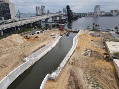 December 2025: The new McCoys Creek channel at the Outfall and ongoing site work, including utilities improvements.