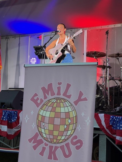Emily Mikus preforming a song at Freedom Fest 250