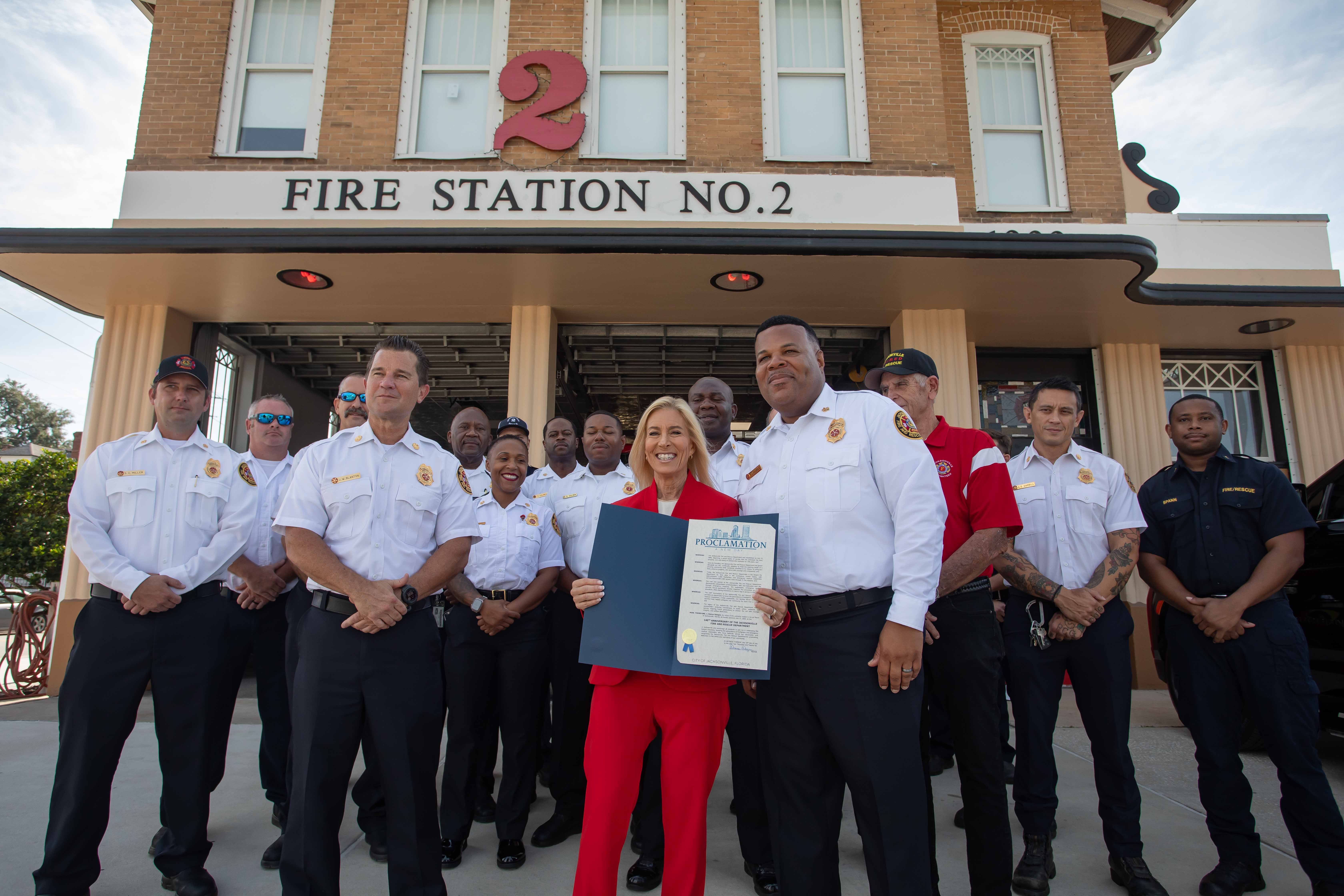 Mayor and members of JFRD standing in front of fire station no. 2