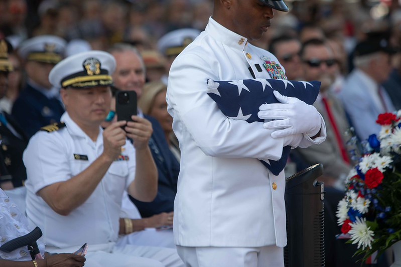 Retired Master Chief Mack Ellis with a American Flag preforming "Old Glory" at Memorial Day 2026 service