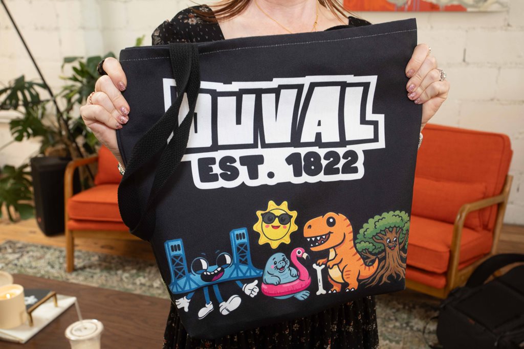 woman holding duval tote bag