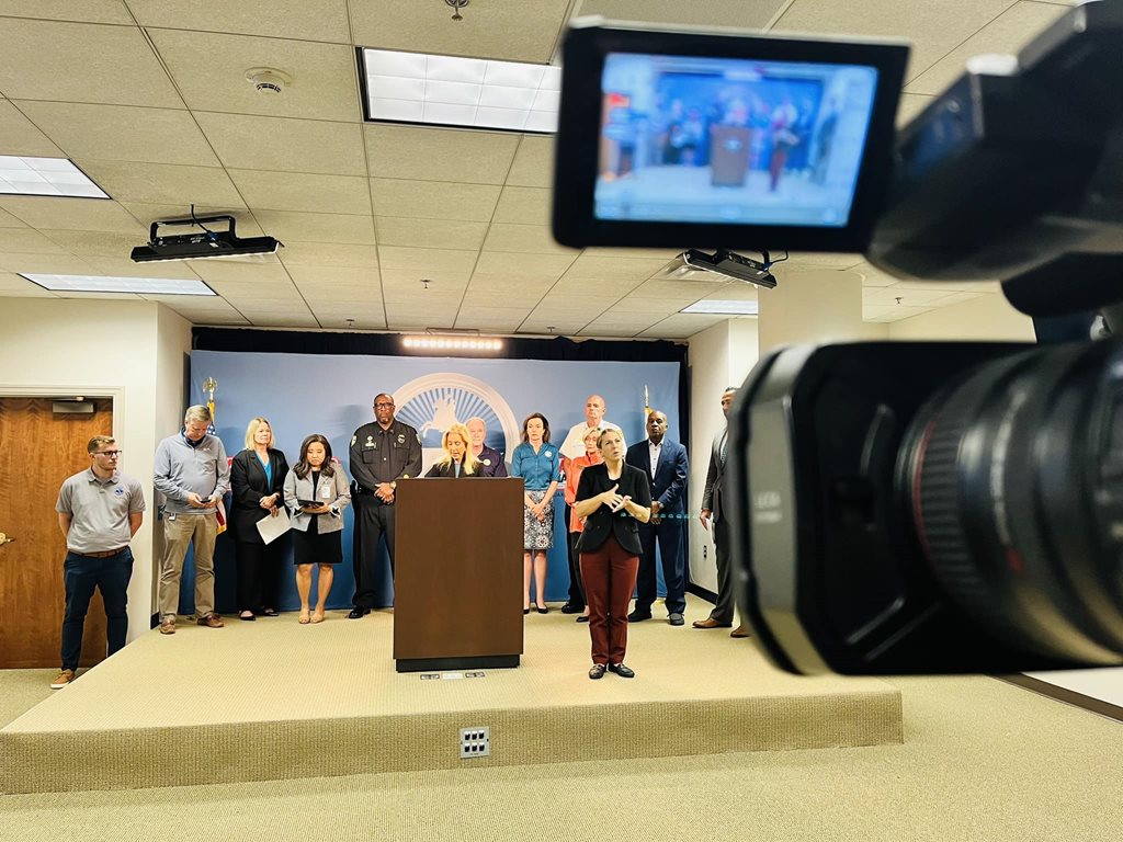 Mayor Deegan and city official standing behind podium at press conference