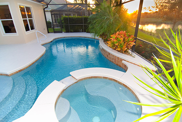 Pool in a screened in porch next to house Pool in a screened in porch next to house