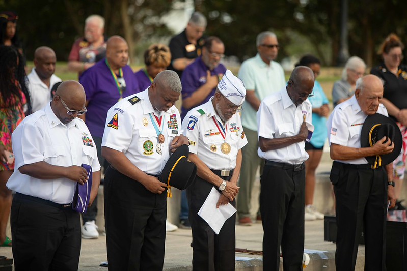 5 gentlemen bowing head for prayer during Purple Heart Ceremony 2026