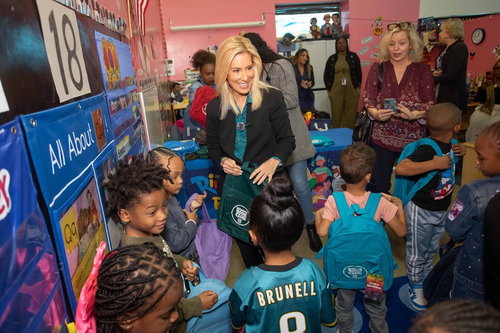 Smiling Mayor surrounded by school children in classroom