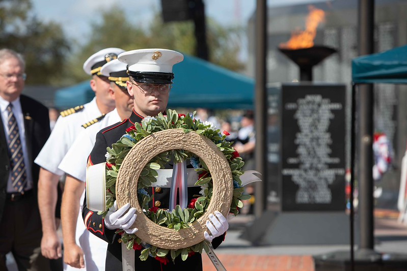 Marine setting wreath at Memorial Wall at Memorial Day 2026 service