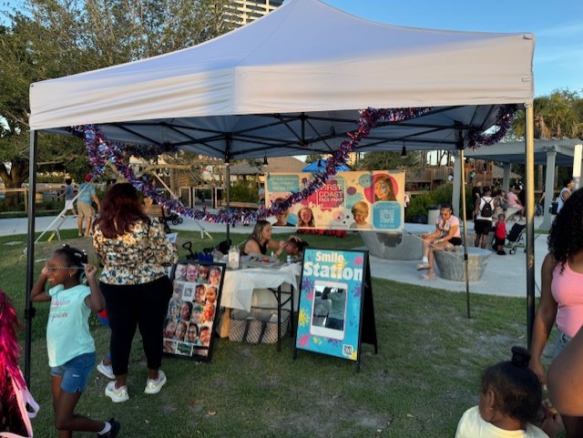 A vendor at Freedom Fest 250 painting the face of a small child
