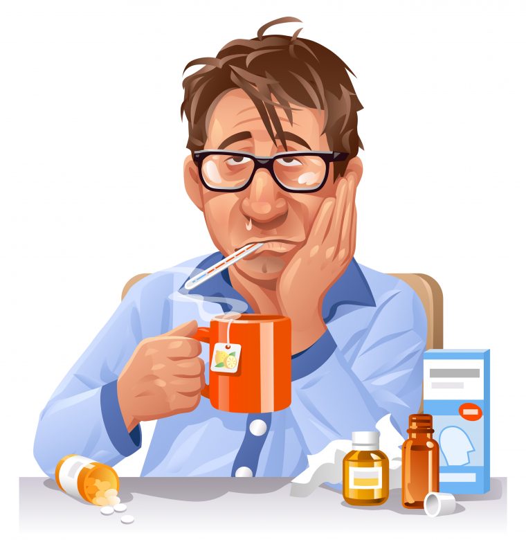a man with flu holding a cup of tea, with thermometer on his month and medicines around him