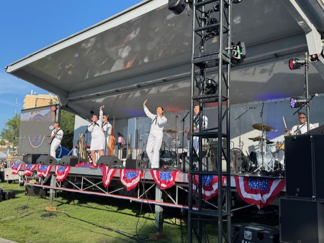 Navy rock band is on stage playing music