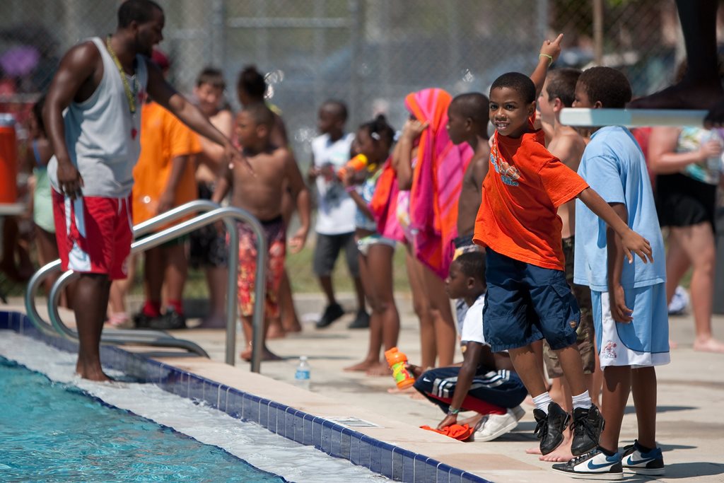 lifeguard and children at a community pool