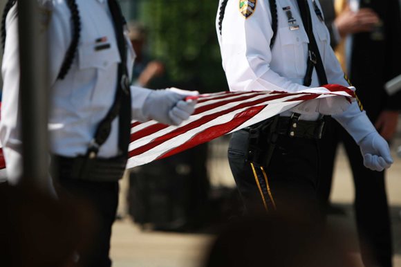 JSO's Honor Guard carry the American flag for the flag folding ceremony at the annual Police Memorial Day Observance on May 4, 2016