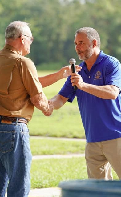 Council Member Mike Gay speaks at the start of the Jr. World Skeet Championship 