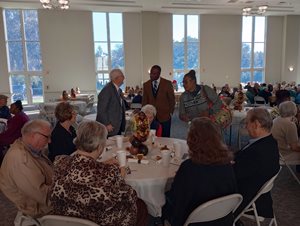 CM-Terrance-Freeman-Speaking-with-Richard-Moyers,-standing,-around-the-table-left-to-right-–-Bernice-Dean,-AJ-Roberts,-LaDonna-Roberts,-Linda-Hoyle,-Gary-Hoyle-and-Nan-Moyers.jpg