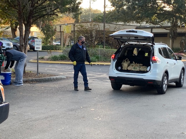Photo of Council Member Ferraro assisting in loading up a Constituents vehicle with Food and Toys.