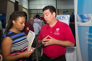 A job seeker talking to an employer at the 2014 Citywide Job Fair