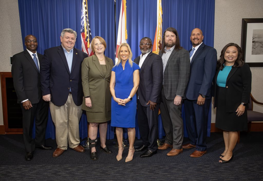 New hires posing with Mayor Deegan