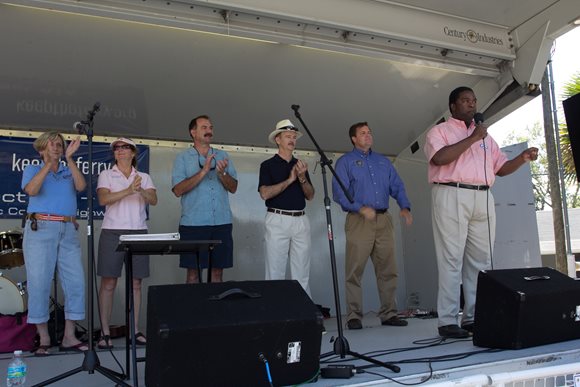 Photo of Council Member John Crescimbeni and members of the St. Johns River Ferry Commission listening as Mayor Brown addresses the attendees at the 2013 Ferry Fest.
