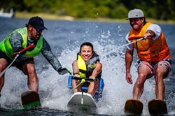 Disabled woman water skiing with assistance