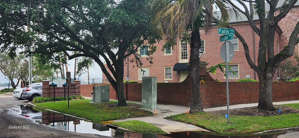 Street sign, apartment building, and park sign