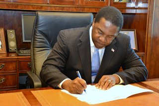 Mayor Brown singing his economic development legilsation, approved unanimously by City Council, into law