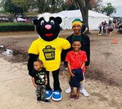 fight blight stripes d. skunk mascot poses with children