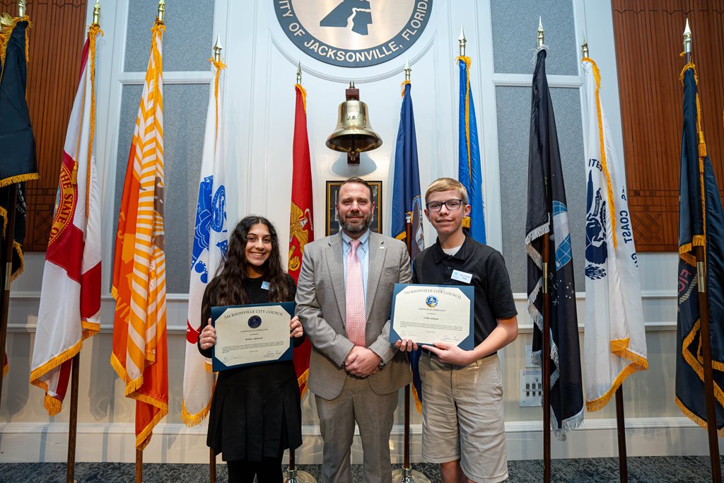 CP Carrico pictured with Page Program participants Rodina Aljubouri and Collin Johnson following the certificate presentation January 13, 2026 at the City Council meeting in the City Council Chamber, Jacksonville, FL.