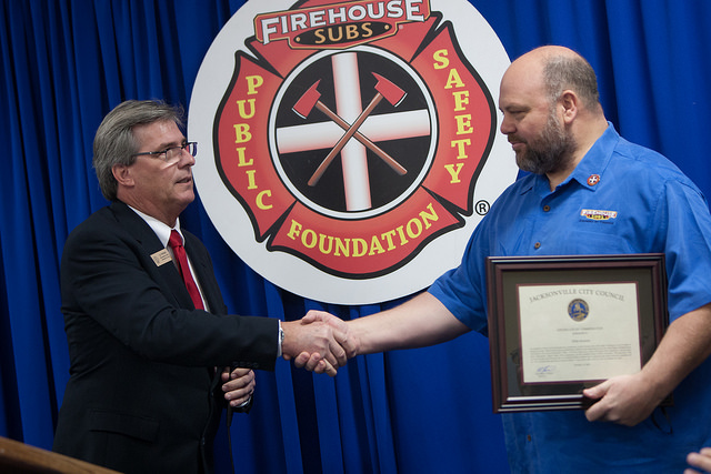 November 13, 2018 photo of Council Member Al Ferraro presenting Robin Sorenson with a certificate of commendation. 