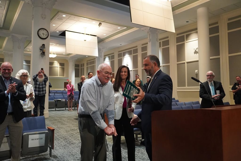 Council Member Gay presenting District 2 hero Mr. J.D. Thompson with a Resolution. Commending him for his heroic rescue of lineman Randall Champion on July 17, 1967. 