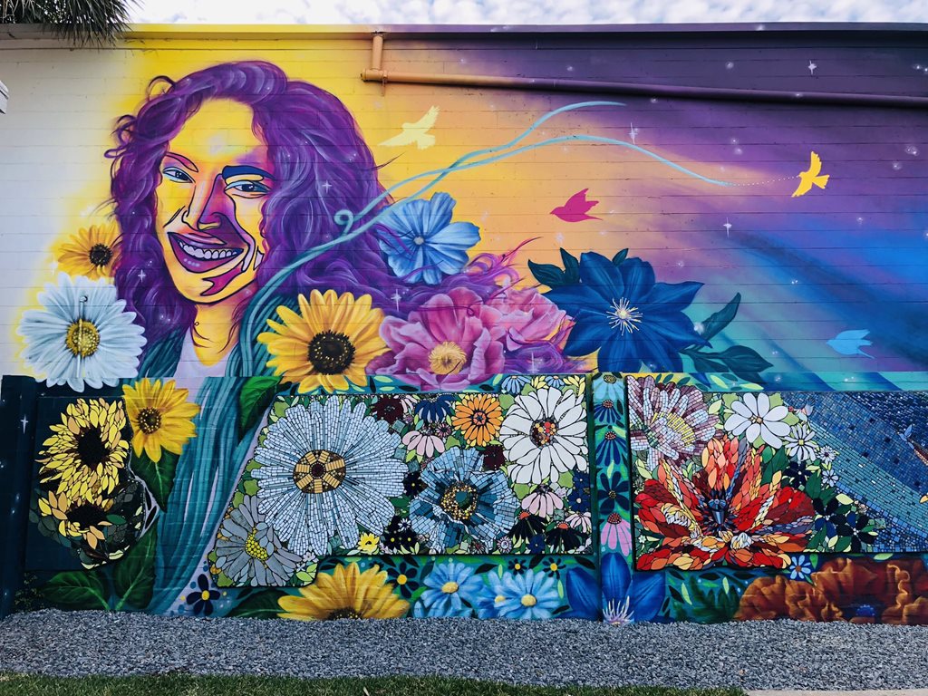 Rethreaded mural and mosaic of woman and flowers