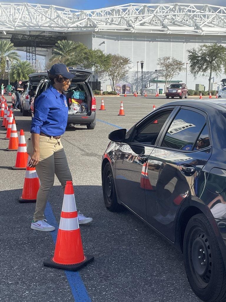 CM Clark-Murray speaking with a participant at the food distribution.