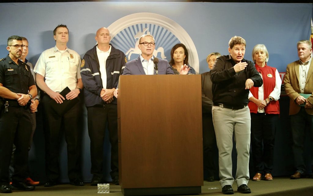 mayor and others behind podium for press conference