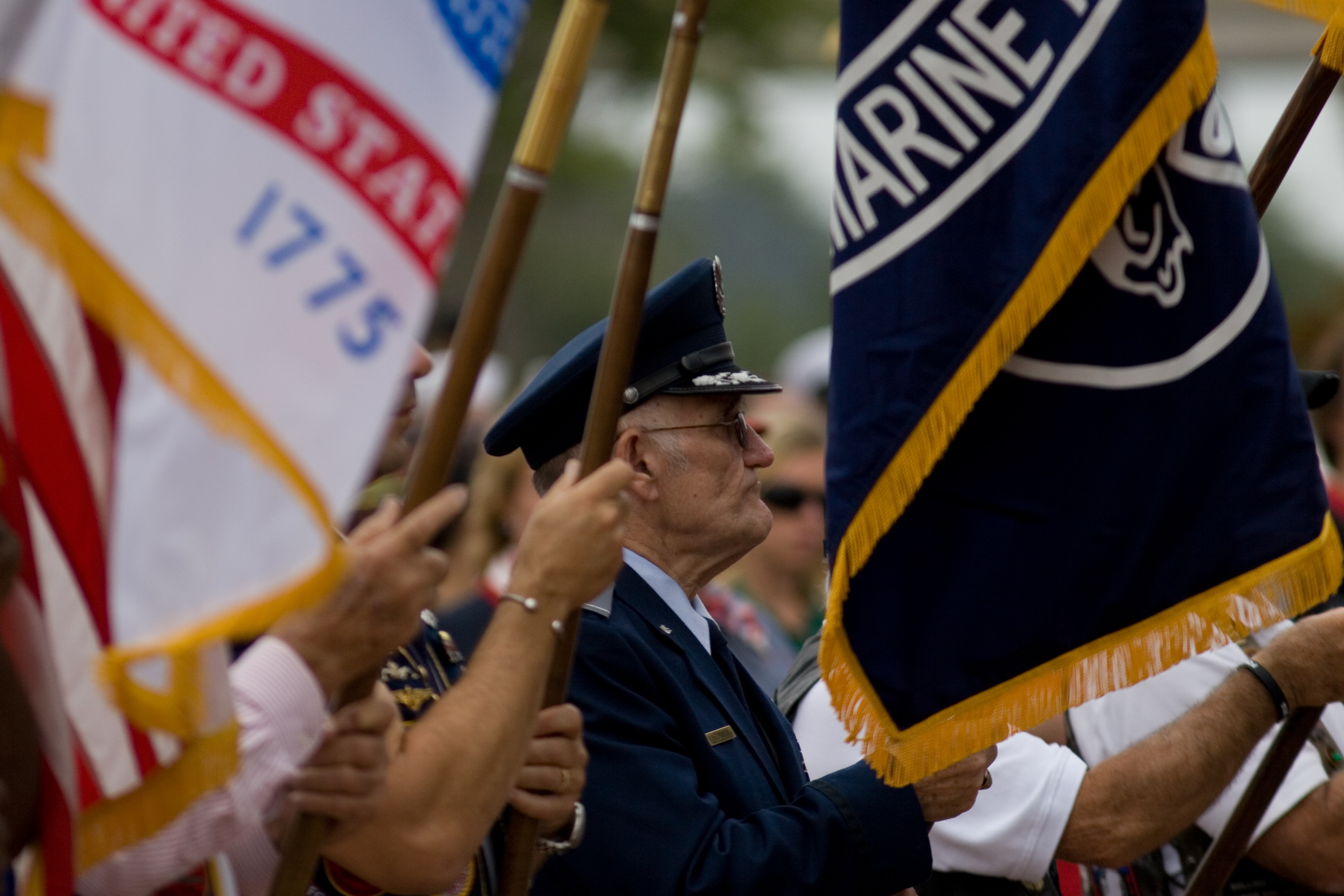 man in uniform holding a flag