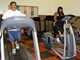 Two adults working out on cardio equipment at the Cecil Gym and Fitness Center