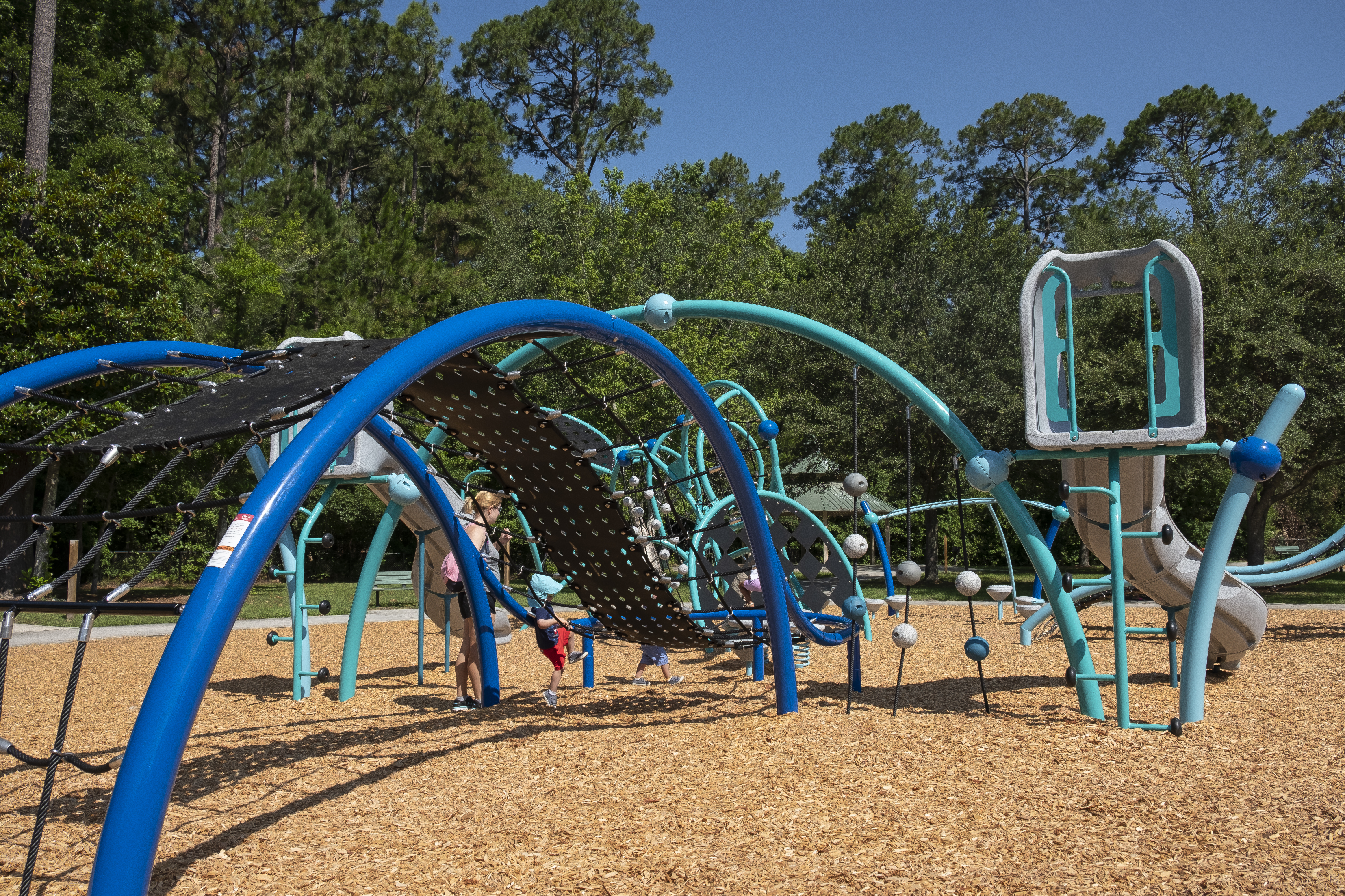 blue and turquoise playscape on mulch at playground