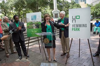 Photo of Friends of Hemming Park board member Diane Brunet-Garcia unveiling the new logo.