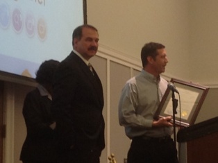 Photo of Council Member Crescimbeni standing beside Council Member Holt during the presentation of a framed Resolution recognizing April 14 to 20, 2013 as National Library Week.  Click to read more about this event.