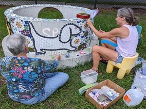 volunteers working on mosaic