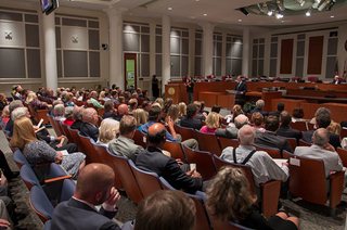 Photo of audience in the Council Chamber listening as Council President Yarborough gives his remarks.