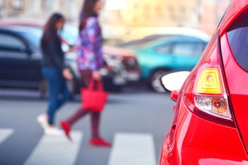 car waiting for pedestrians to cross the street