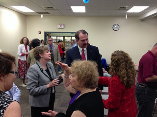 Photo of Council Member John Crescimbeni and Library Director Barbara Gubbin speaking with the library patrons.